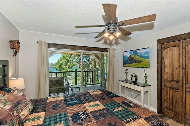 bedroom with a ceiling fan, a textured ceiling, and access to exterior