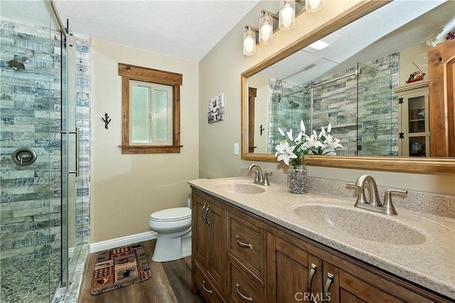 28844 Cedar Dr, Lake Arrowhead, CA 92352 - bathroom with a stall shower, double vanity, and wood finished floors