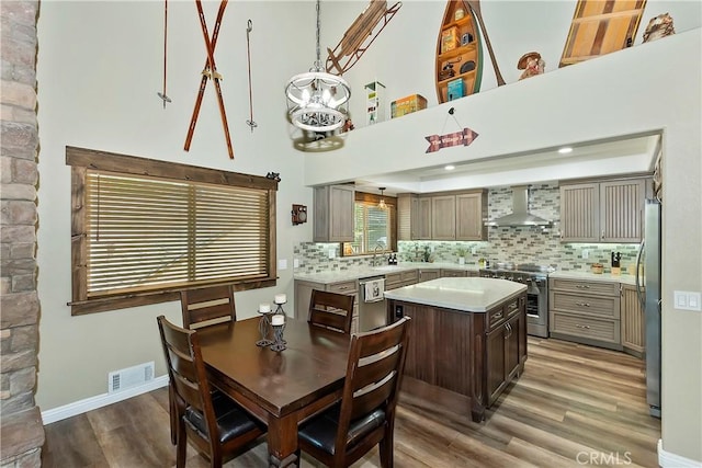 dining area with visible vents, baseboards, and wood finished floors