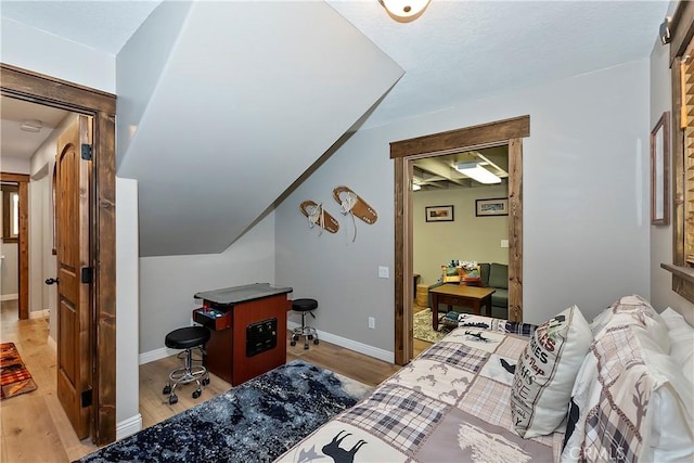 bedroom with baseboards and light wood finished floors