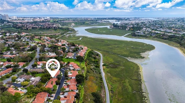 drone / aerial view with a water view and a residential view