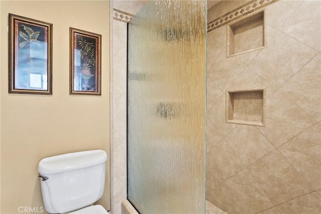 full bathroom with toilet and tiled shower