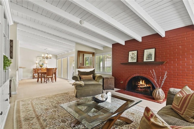 living area with beamed ceiling, a fireplace, wood ceiling, and a notable chandelier