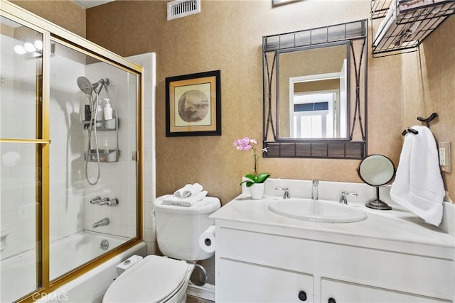 full bathroom with shower / bath combination with glass door, toilet, visible vents, and vanity