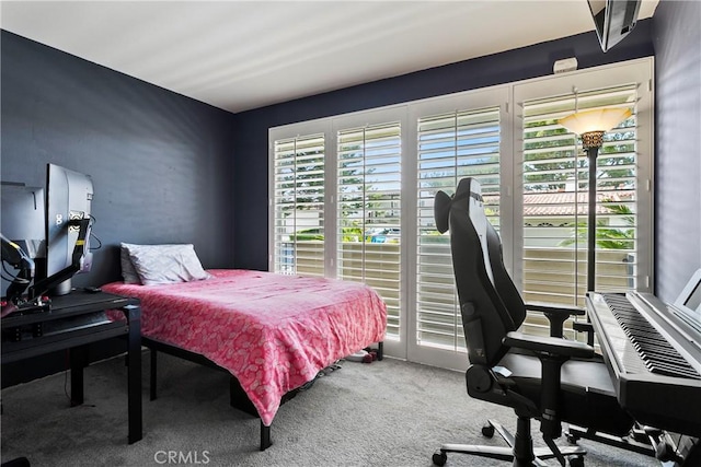 carpeted bedroom with access to exterior