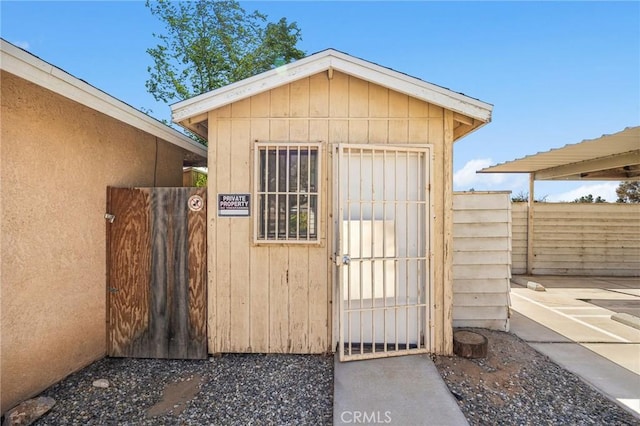 view of shed with a gate and fence