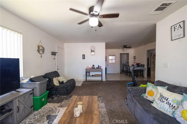carpeted living area with a ceiling fan and visible vents