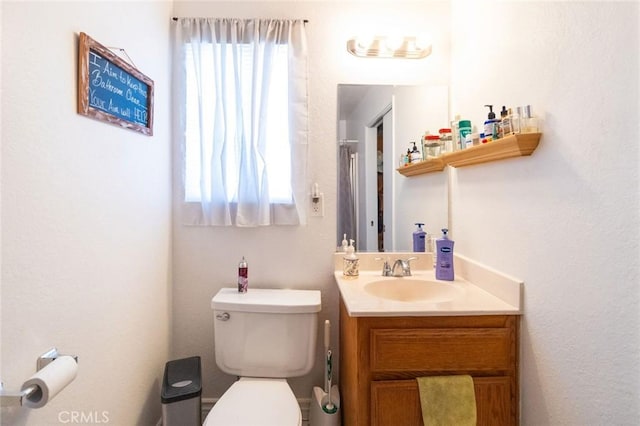 bathroom featuring toilet and vanity