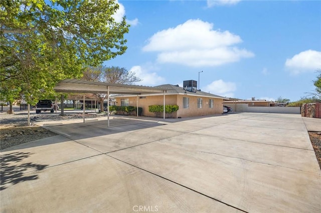 exterior space featuring stucco siding and concrete driveway