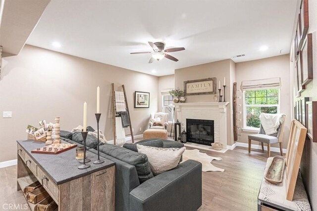 3065 Tierra Mesa, Atascadero, CA 93422 - living room featuring a fireplace with flush hearth, a ceiling fan, light wood-style floors, baseboards, and recessed lighting