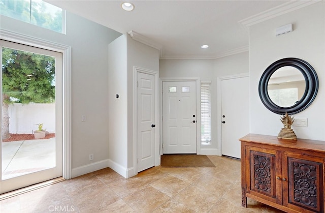 foyer with crown molding, baseboards, and recessed lighting