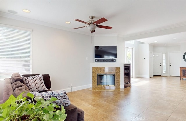 living room with a high end fireplace, baseboards, light tile patterned floors, and a ceiling fan