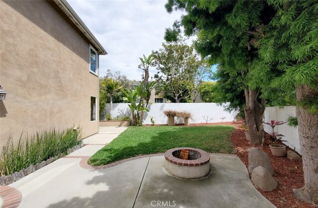 18672 Park Meadow Ln, Huntington Beach, CA 92648 - view of yard featuring an outdoor fire pit, a patio area, and a fenced backyard