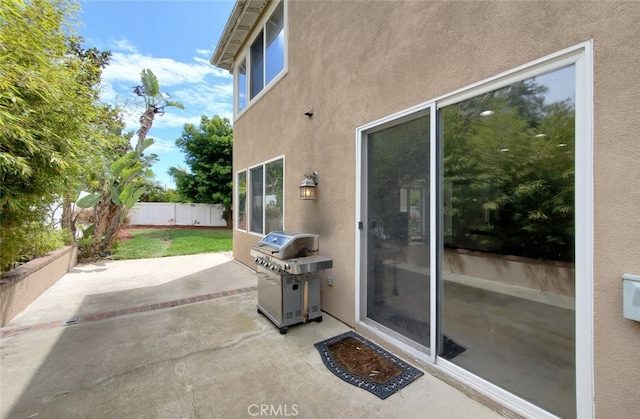 view of patio with fence and grilling area