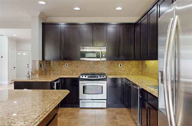 kitchen featuring dark brown cabinetry, backsplash, crown molding, light stone countertops, and stainless steel appliances