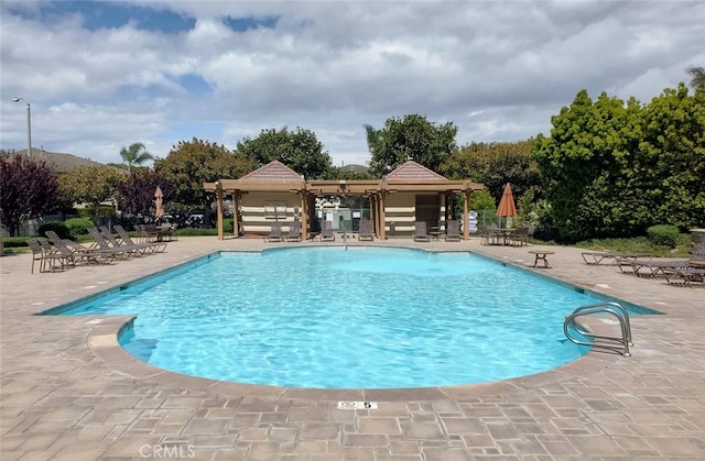 pool with a gazebo and a patio area