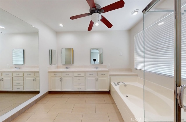 full bathroom featuring a sink, a garden tub, a ceiling fan, and double vanity