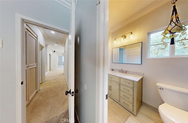 18672 Park Meadow Ln, Huntington Beach, CA 92648 - half bathroom with crown molding, toilet, baseboards, and vanity