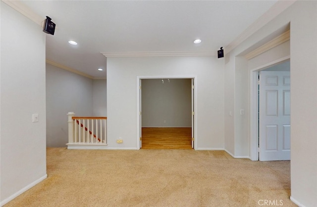 empty room featuring crown molding, recessed lighting, baseboards, and carpet floors