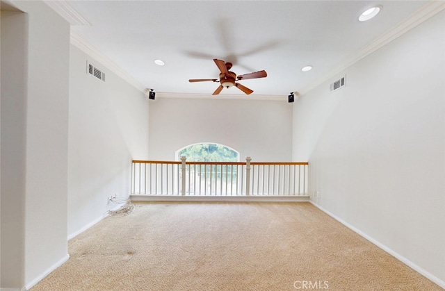 empty room featuring ceiling fan, visible vents, and carpet