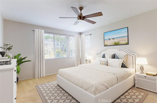 18672 Park Meadow Ln, Huntington Beach, CA 92648 - bedroom featuring baseboards, ceiling fan, and light colored carpet