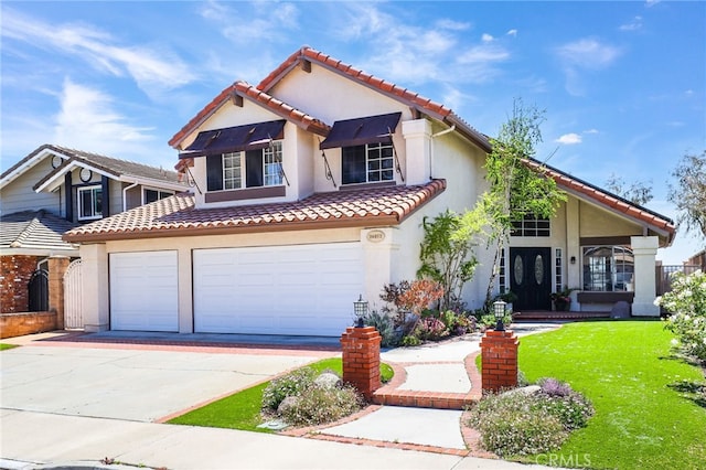 mediterranean / spanish home with a garage, a front yard, stucco siding, concrete driveway, and a tile roof