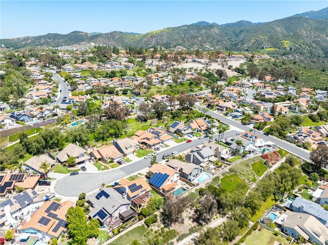 birds eye view of property with a mountain view and a residential view