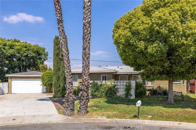 single story home with a garage, fence, a front yard, and stucco siding