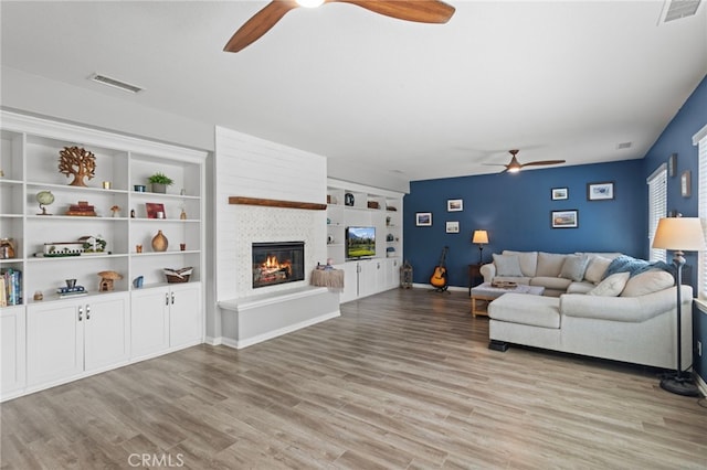 32701 Juniper Berry Dr, Winchester, CA 92596 - living room with a ceiling fan, a large fireplace, and light wood-style floors