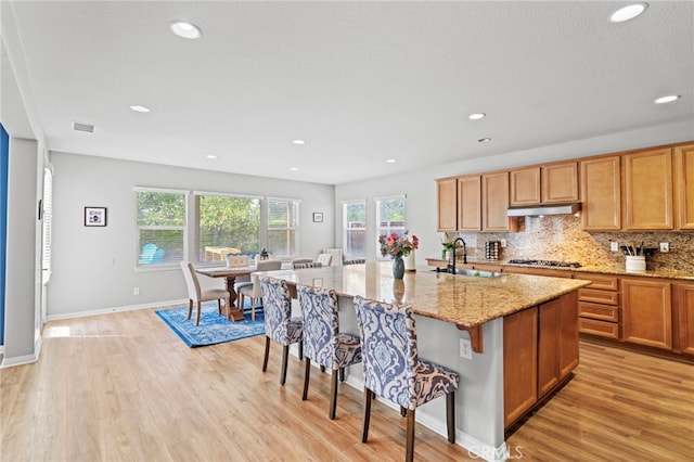 32701 Juniper Berry Dr, Winchester, CA 92596 - kitchen featuring a sink, under cabinet range hood, stainless steel gas stovetop, light wood-style floors, and recessed lighting