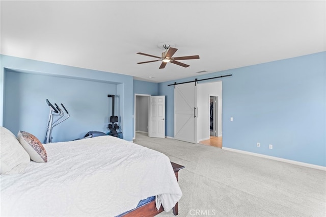 32701 Juniper Berry Dr, Winchester, CA 92596 - bedroom with a barn door, carpet flooring, baseboards, and ceiling fan