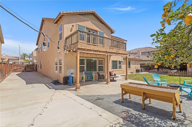 32701 Juniper Berry Dr, Winchester, CA 92596 - rear view of property with an outdoor fire pit, stucco siding, a patio, a gate, and a balcony