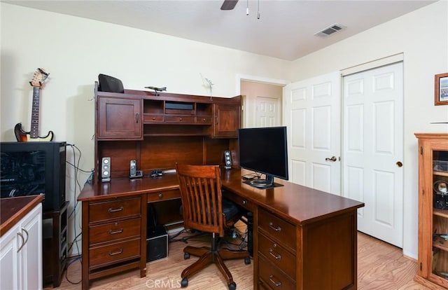 office area featuring a ceiling fan, visible vents, and light wood-style floors