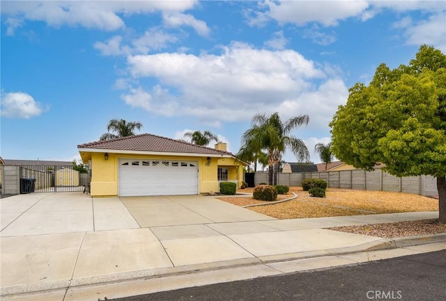 ranch-style home featuring a tiled roof, a garage, fence, concrete driveway, and stucco siding