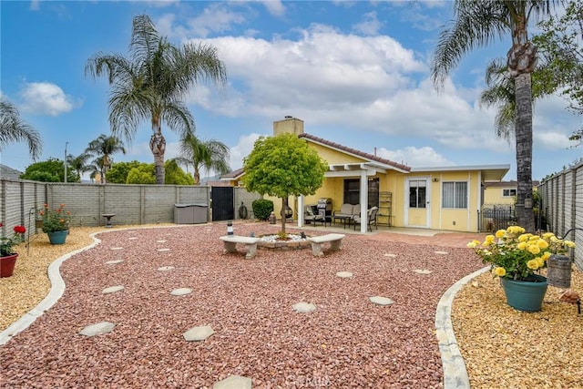 exterior space with a fenced backyard, stucco siding, a chimney, and a patio area