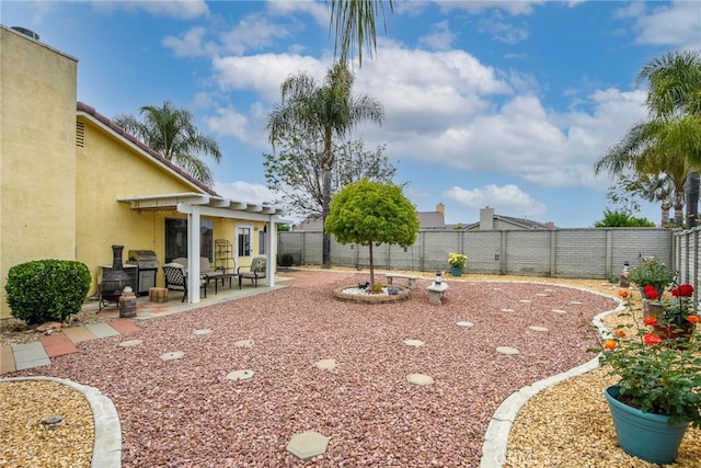 view of yard featuring a fenced backyard, a pergola, and a patio area