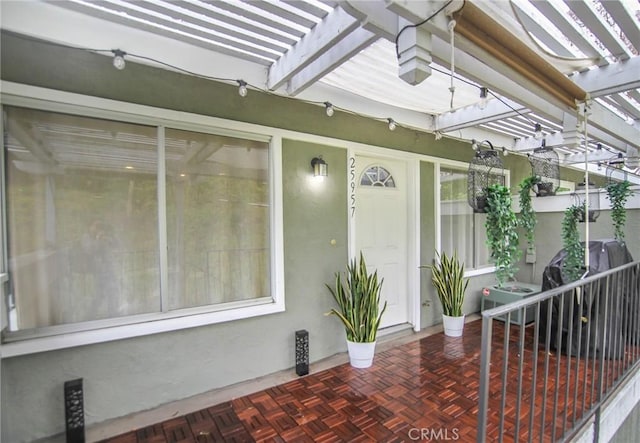 doorway to property featuring a pergola