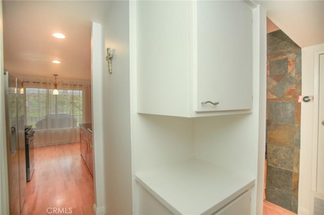 bathroom with recessed lighting and wood finished floors