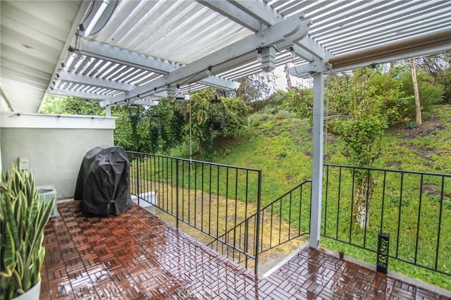 view of patio with grilling area and a pergola