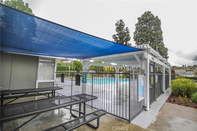 community pool featuring a patio area and fence