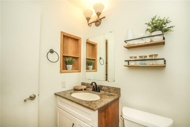 bathroom with toilet and vanity