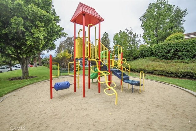 community jungle gym featuring a yard