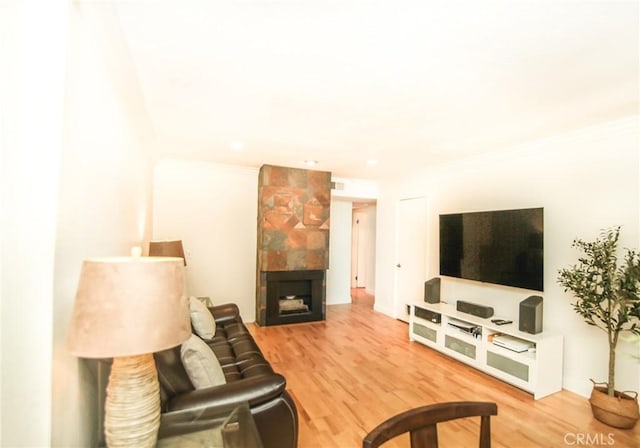 25957 Via Pera Unit C4, Mission Viejo, CA 92691 - living room featuring ornamental molding, wood finished floors, and a tile fireplace