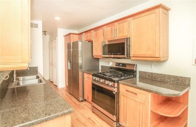25957 Via Pera Unit C4, Mission Viejo, CA 92691 - kitchen with a sink, light brown cabinetry, stainless steel appliances, and light wood finished floors