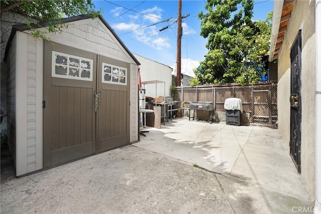 view of shed with fence