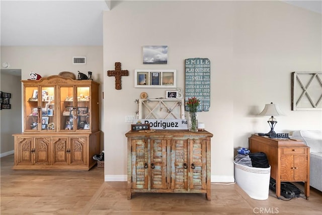 interior space with visible vents, baseboards, and wood finished floors