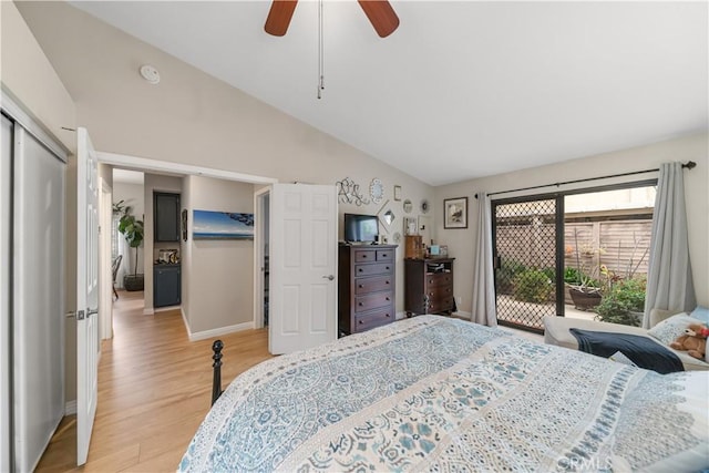 bedroom featuring a ceiling fan, baseboards, vaulted ceiling, and light wood finished floors