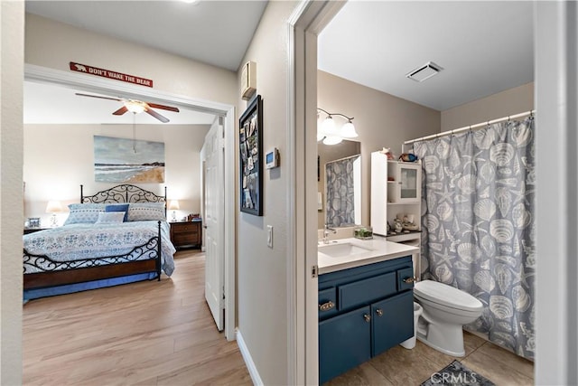 bathroom featuring a ceiling fan, visible vents, vanity, toilet, and ensuite bathroom