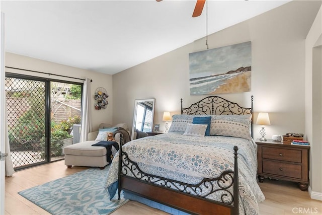bedroom with a ceiling fan, wood finished floors, and access to exterior