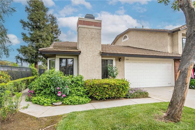 view of front facade featuring a garage, fence, stucco siding, a chimney, and concrete driveway
